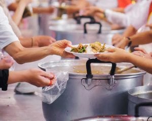 people serving community meal